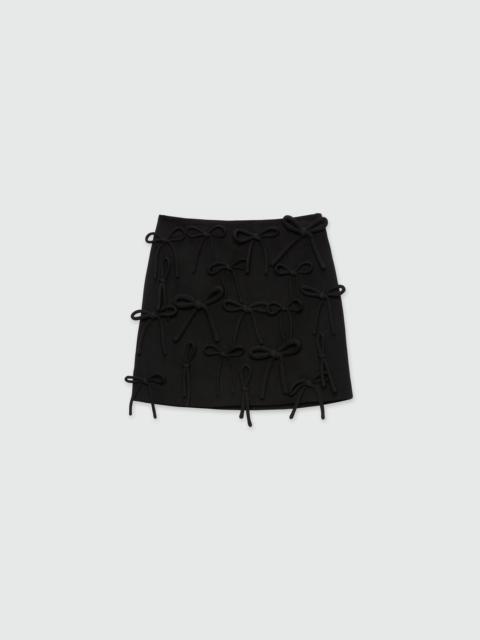 Black miniskirt in double crepe cady with bow detail