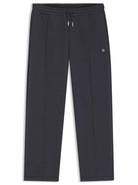 PINTUCK-PLEAT TRACKSUIT BOTTOMS IN A RELAXED FIT