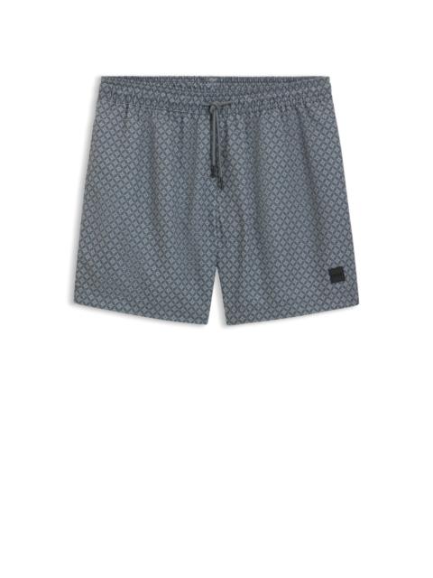 SWIM SHORTS WITH LOGO BADGE AND PRINT