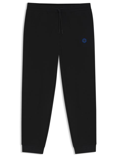 COTTON-TERRY TRACKSUIT BOTTOMS WITH HAPPY HUGO LOGO PATCH