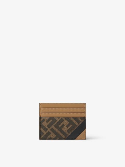 Card holder with six slots and flat central pocket. Made of textured fabric with FF motif in brown a