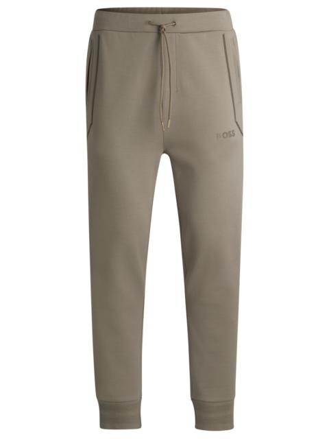 TRACKSUIT BOTTOMS WITH MIRROR-EFFECT LOGO