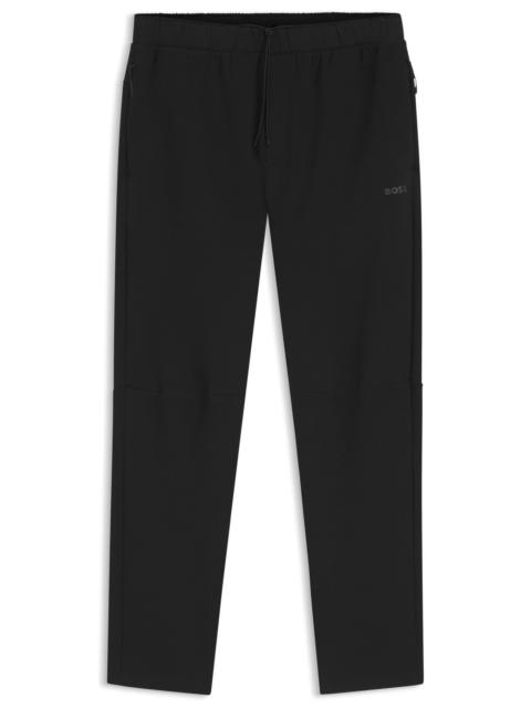 REFLECTIVE-DETAIL TRACKSUIT BOTTOMS IN A REGULAR FIT