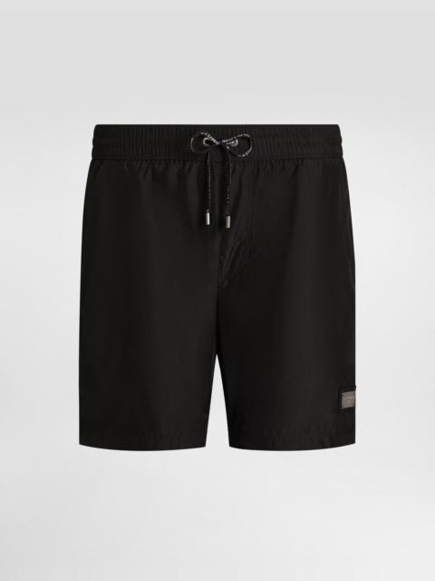 Mid-length swim trunks with logo tag