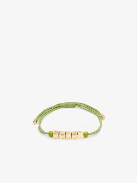 Bracelet with small cubes that create the Fendi lettering. Fine acid green cord and orbs in tone on 