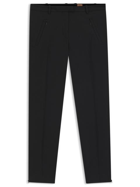 CROPPED SLIM-FIT TROUSERS WITH ZIPPED HEMS