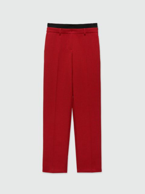 Red trousers with check pattern