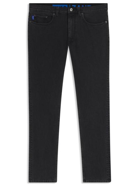 SKINNY-FIT JEANS IN WASHED BLACK DENIM