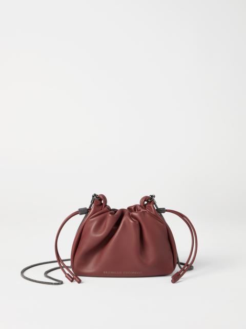 Mellow mini bucket bag in soft leather with precious chain