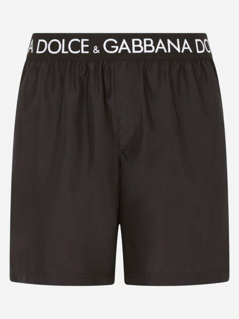 Mid-length swim trunks with branded stretch waistband