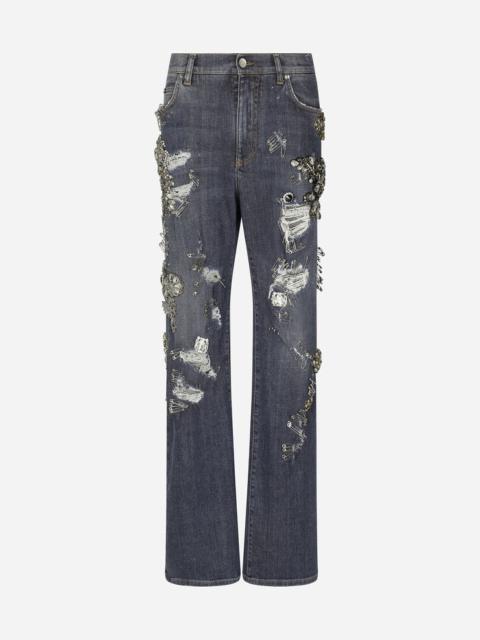 Denim jeans with ripped details and appliqués