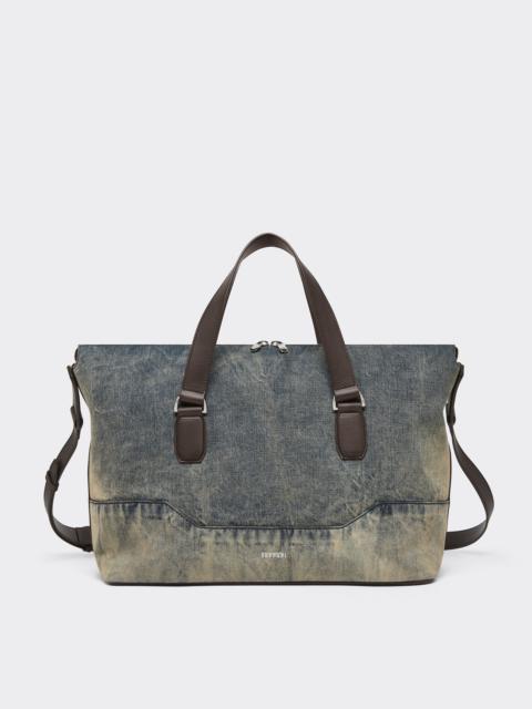 Acid-washed denim and leather duffle bag