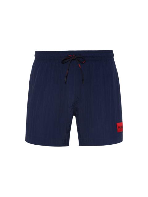 QUICK-DRY SWIM SHORTS WITH RED LOGO LABEL