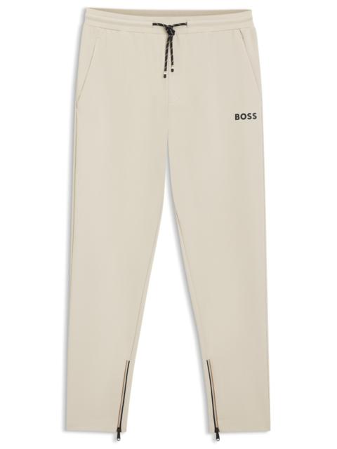 STRETCH-GABARDINE TRACKSUIT BOTTOMS WITH ZIPPED HEMS
