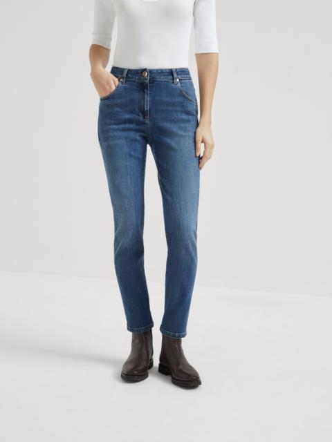 Stretch denim slim five-pocket trousers with shiny leather tab