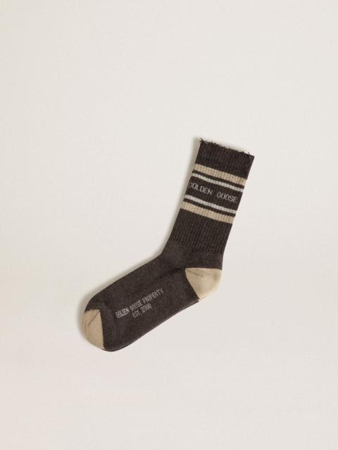 Dark grey socks with distressed details and cream and worn-white stripes