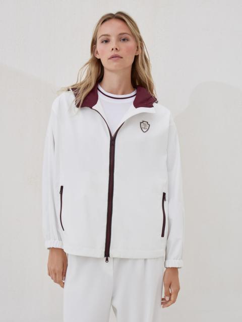 Nylon hooded outerwear jacket with logo and precious trims