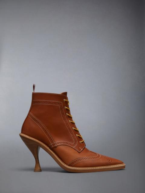 VACCHETTA WINGTIP CURVED HEEL BOOT
