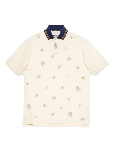 Cotton polo with symbols embroidery