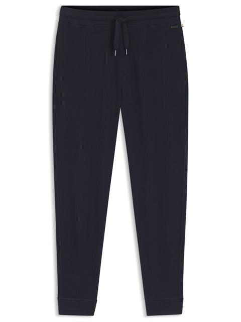WAFFLE-STRUCTURE TRACKSUIT BOTTOMS IN A COTTON BLEND