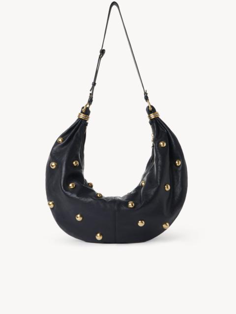 LARGE BRACELET HOBO BAG IN GRAINED LEATHER WITH STUDS