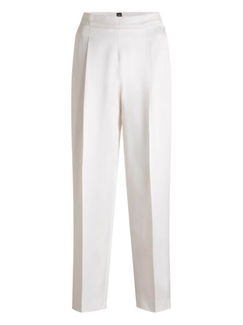 pleated-front tailored trousers