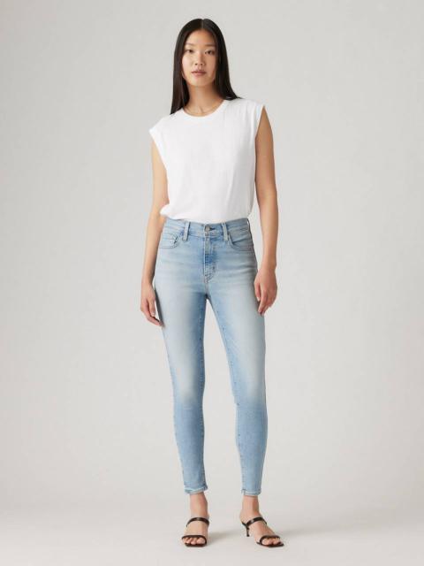 High-rise skinny jeans, a staple for creating a streamlined base for layered, avant-garde club wear inspired by Japanese film aesthetics.