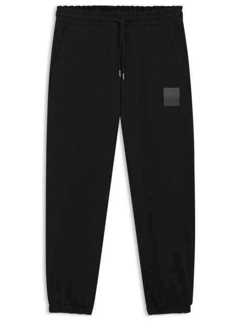 COTTON-TERRY TRACKSUIT BOTTOMS WITH SPLIT LOGO