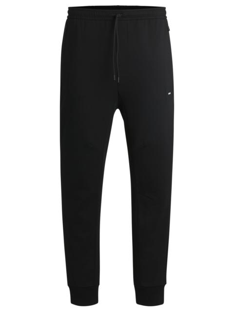 STRETCH TRACKSUIT BOTTOMS WITH LOGO PATCH