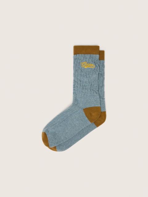 Light blue ribbed socks with brown details and yellow logo