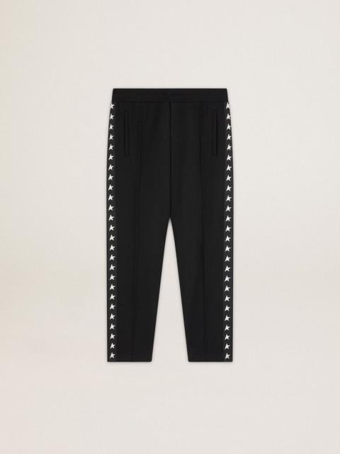 Men's black joggers with white stars on the sides