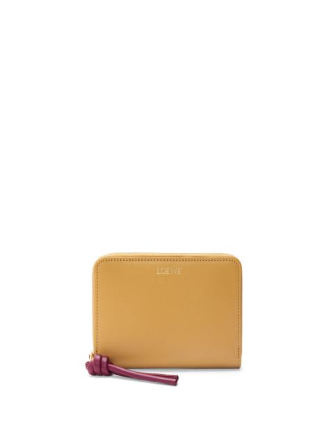 Knot compact zip around wallet in shiny nappa calfskin