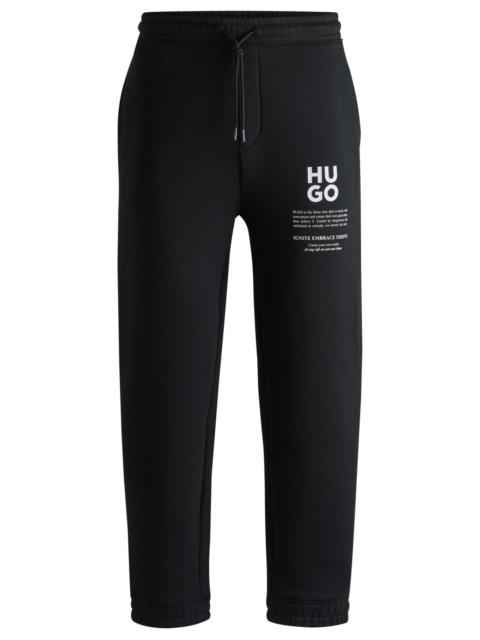 RELAXED-FIT TRACKSUIT BOTTOMS WITH LOGO AND SLOGANS