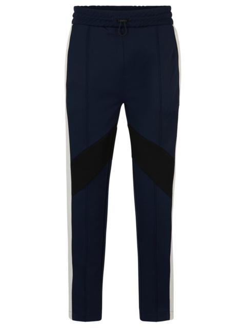 RELAXED-FIT TRACKSUIT BOTTOMS WITH COLOR-BLOCKING