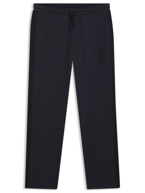 CREST-LOGO TRACKSUIT BOTTOMS IN A REGULAR FIT