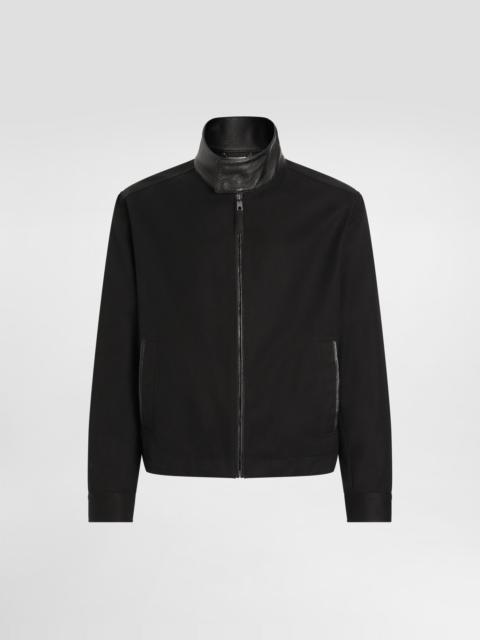 Leather and technical fabric jacket with a high neck and tag