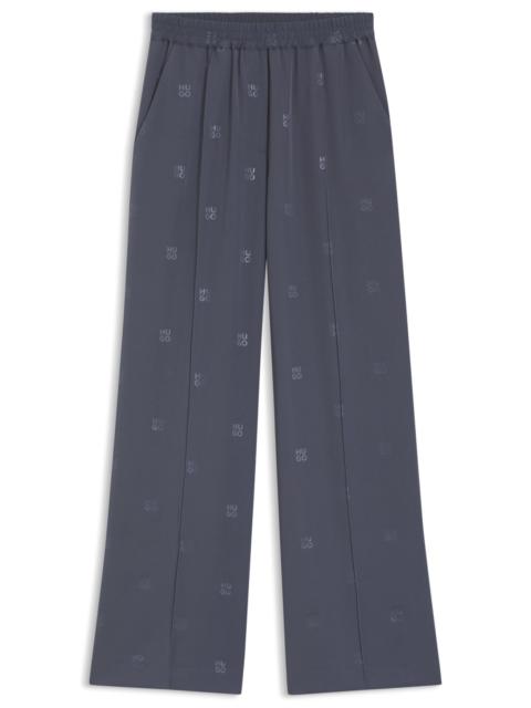 RELAXED-FIT TROUSERS WITH STACKED LOGOS