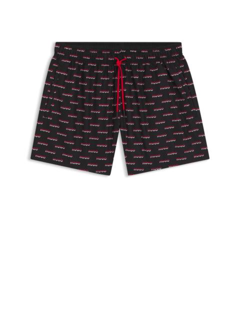 SWIM SHORTS WITH ALL-OVER SPLIT-LOGO PRINT