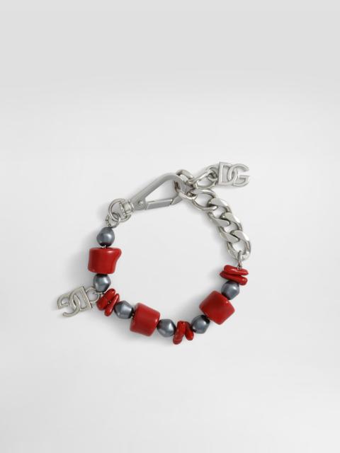 Metal bracelet with coral details and logo
