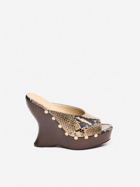 Snake-embossed wedge mules in brown