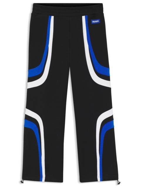 STRETCH-COTTON TRACKSUIT BOTTOMS WITH COLOURFUL PANELLING
