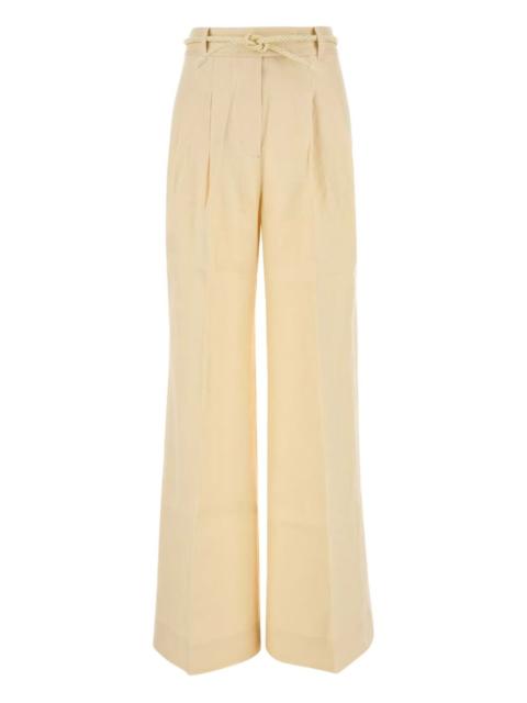 high-waisted pleated trousers