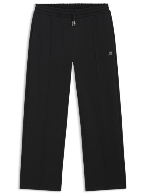 PINTUCK-PLEAT TRACKSUIT BOTTOMS IN A RELAXED FIT