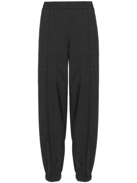 exposed-seam tapered-leg trousers