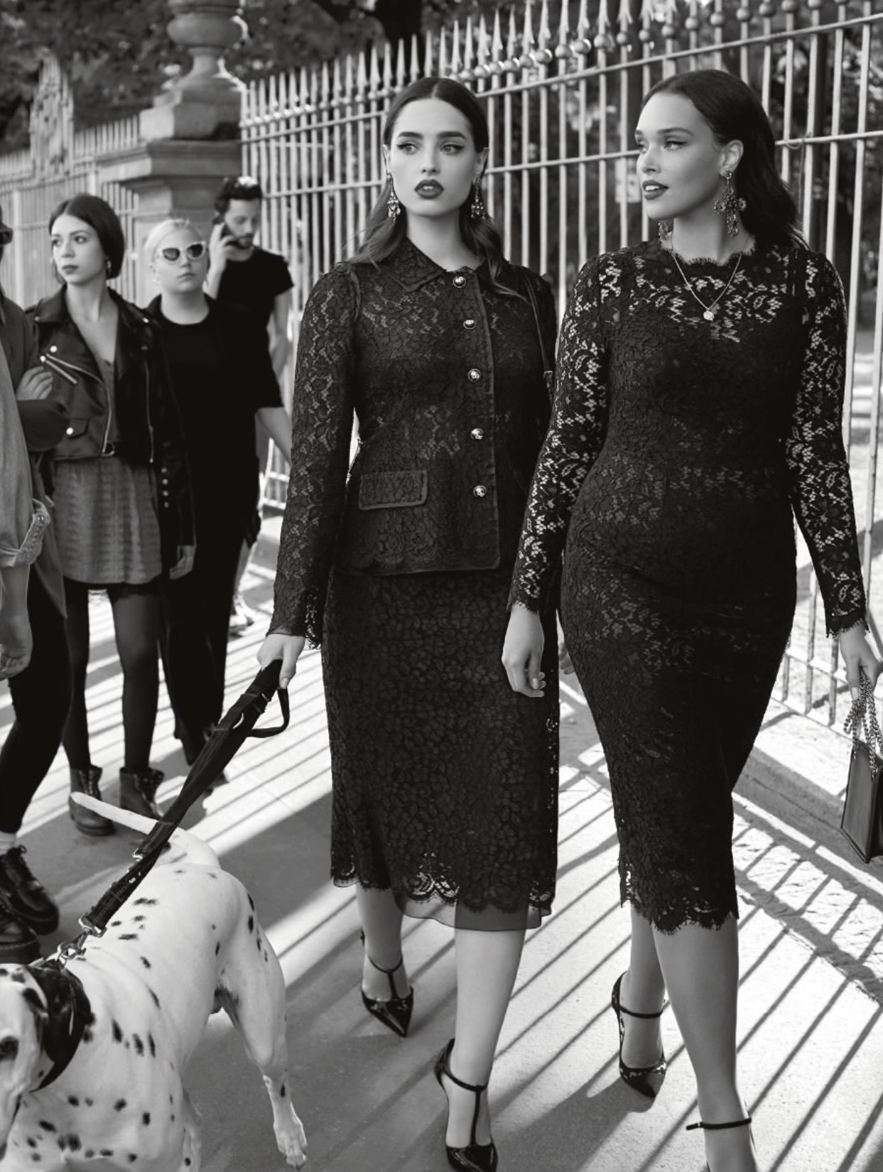 Two black lace runway dresses showcasing the brand's textural DNA.