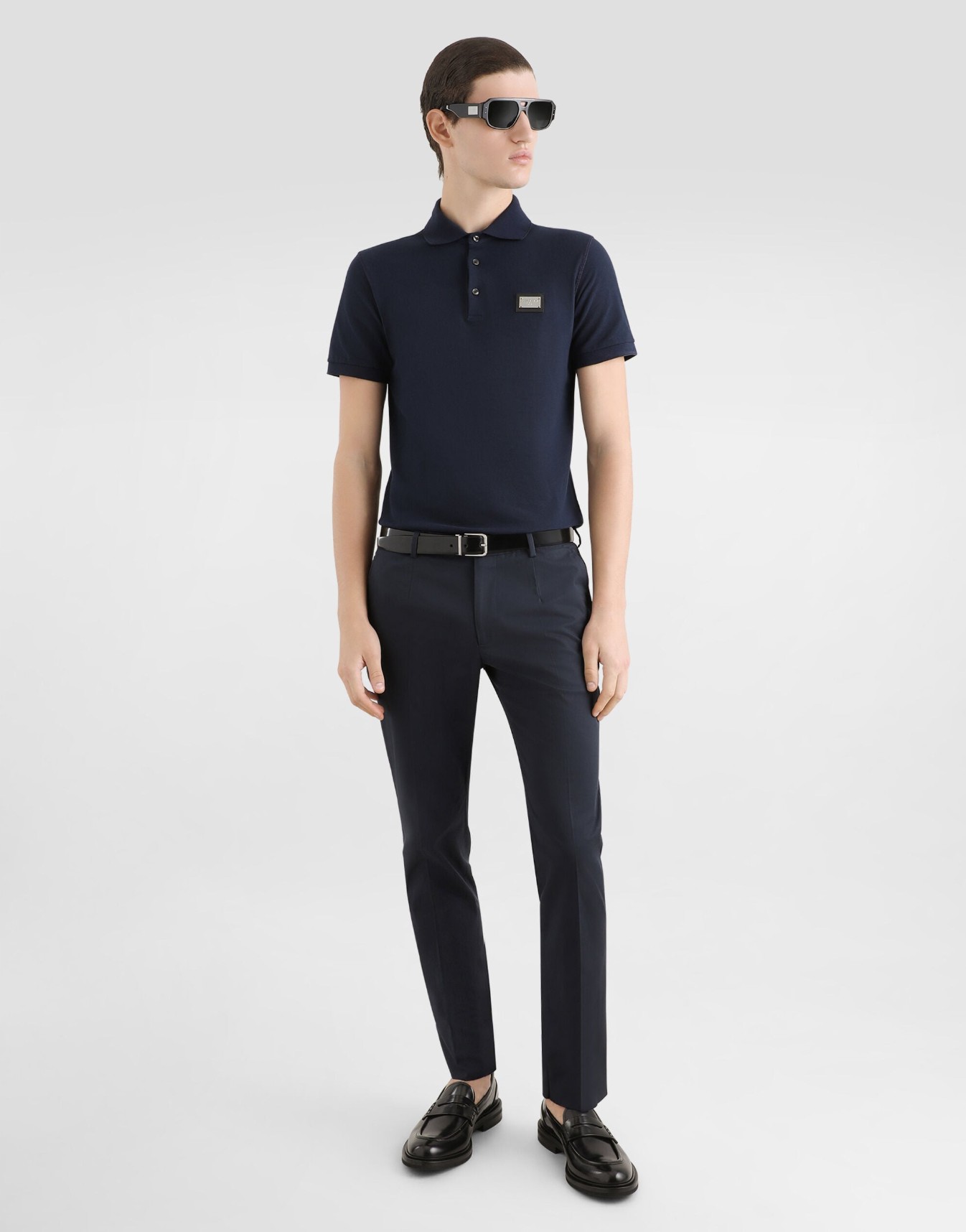 A men's black cotton piqué polo shirt featuring a branded DG logo tag.